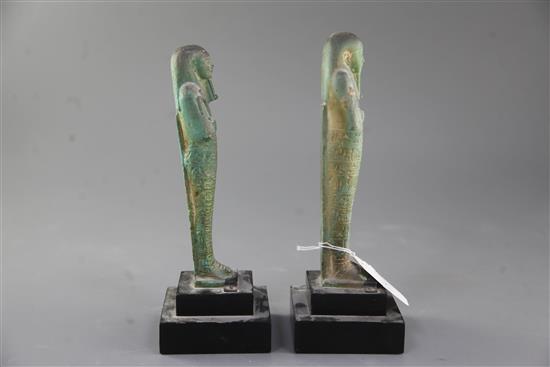 Two Egyptian green glazed composition Shabti, late period, 26th-30th dynasty, circa 664-332 B.C., 18.5 and 19cm excluding ebonised wood